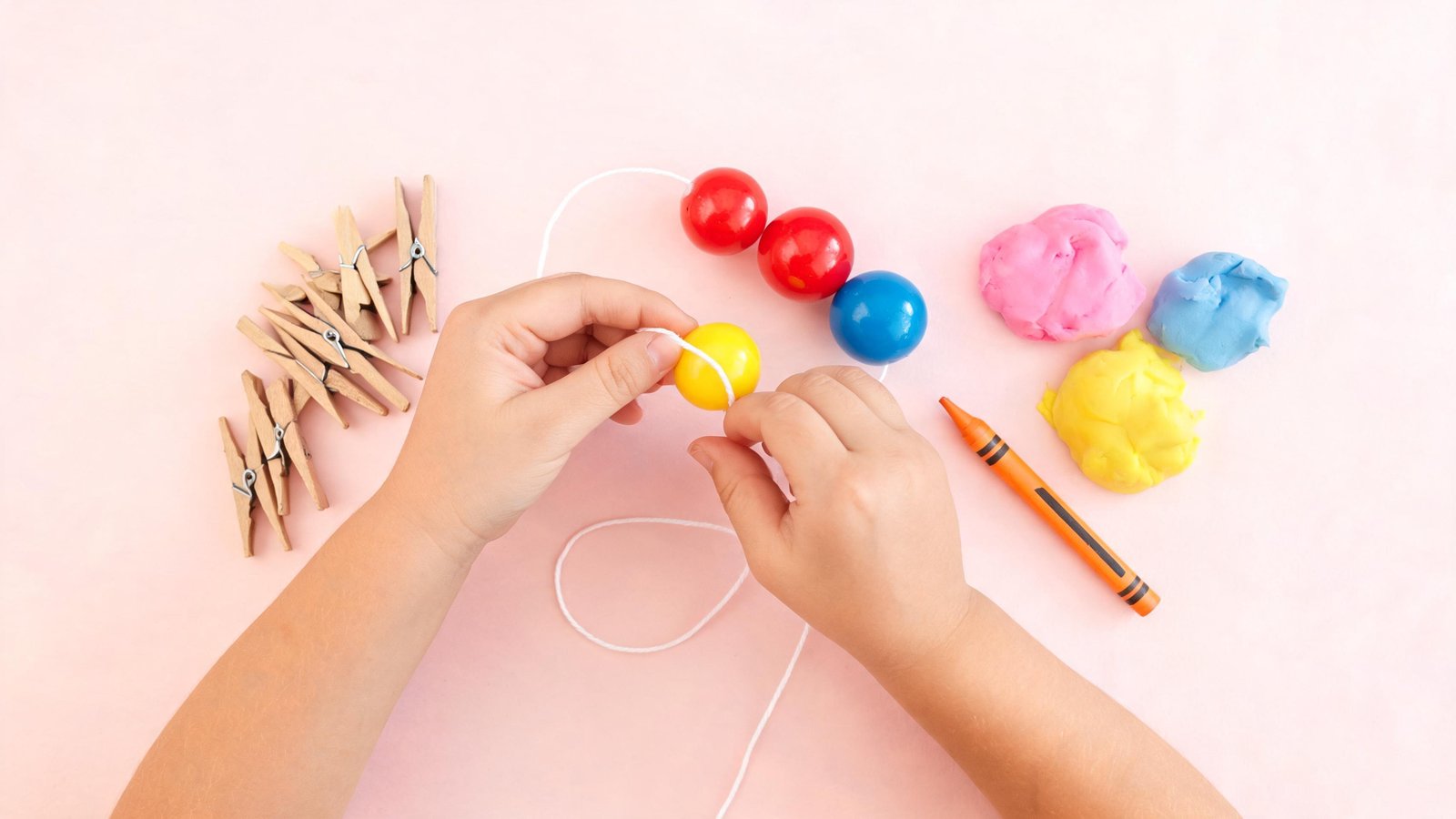 Illustrative image: a child's hands threading beads beside clothespins and play dough.